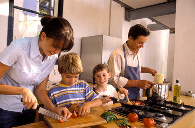 Family Cooking in the Kitchen --- Image by © pixland/Corbis